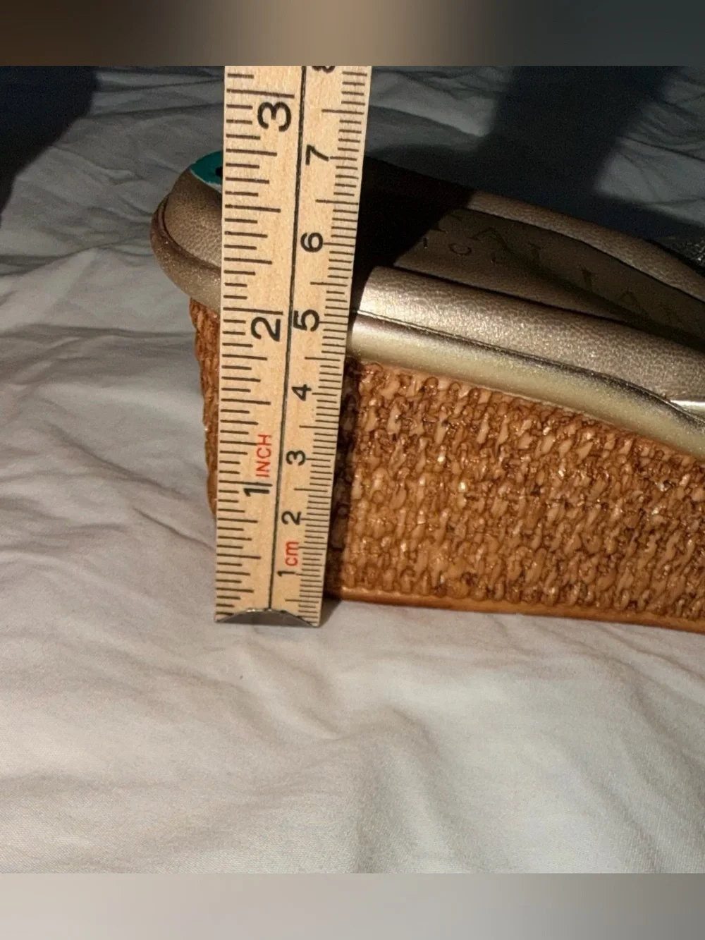 Italian Shoemakers thong wedge sandals feature a metallic gold finish